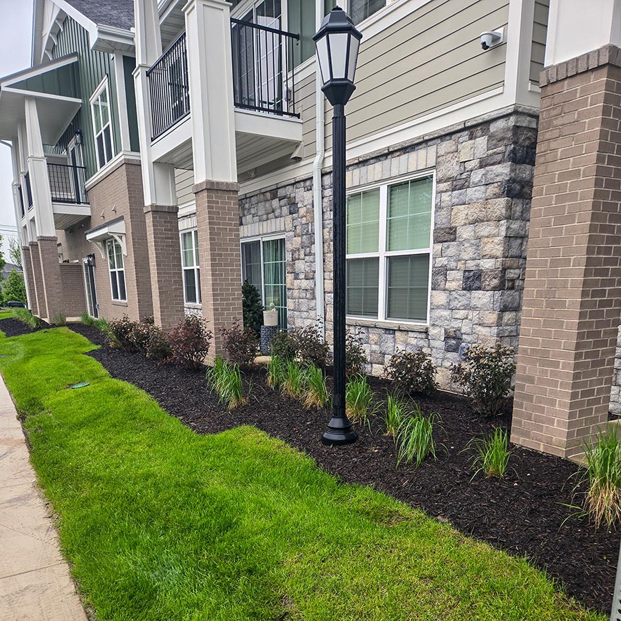 Freshly planted flower beds line the exterior of The Barrymore Senior Living.