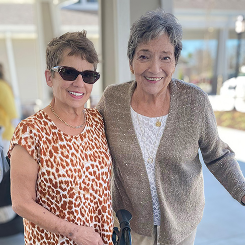Two women smile during a relaxed moment at The Barrymore Senior Living.